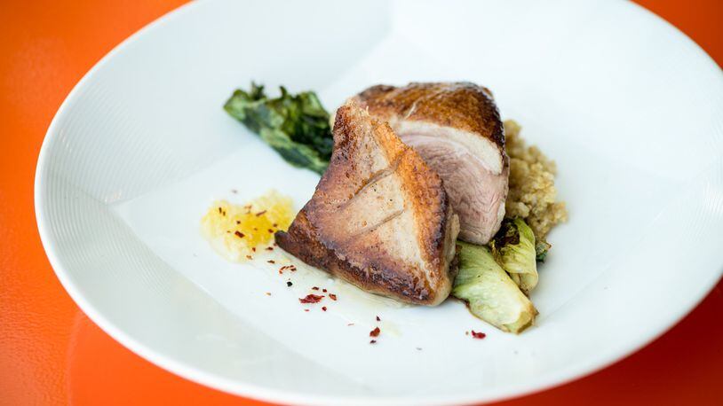 Expat Fowl entree, duck with grilled escarole, Calabrian chili honey, and quinoa. Photo credit- Mia Yakel.