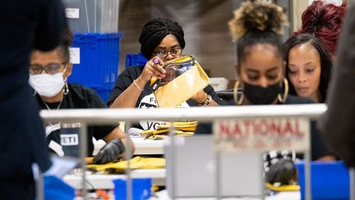 Fulton County elections workers process incoming ballots at the Fulton County Election Preparation Center after polls closed Tuesday, Dec. 6, 2022.  Ben Gray for The Atlanta Journal-Constitution