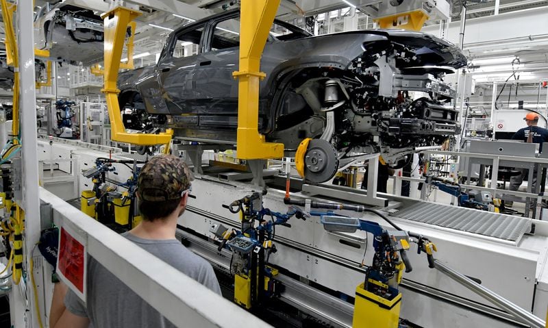 Manufacturing workers assemble the R1T electric vehicle at Rivian in Normal, Ill., on July 20, 2022. (Photo for the Atlanta Journal Constitution by Ron Johnson)
