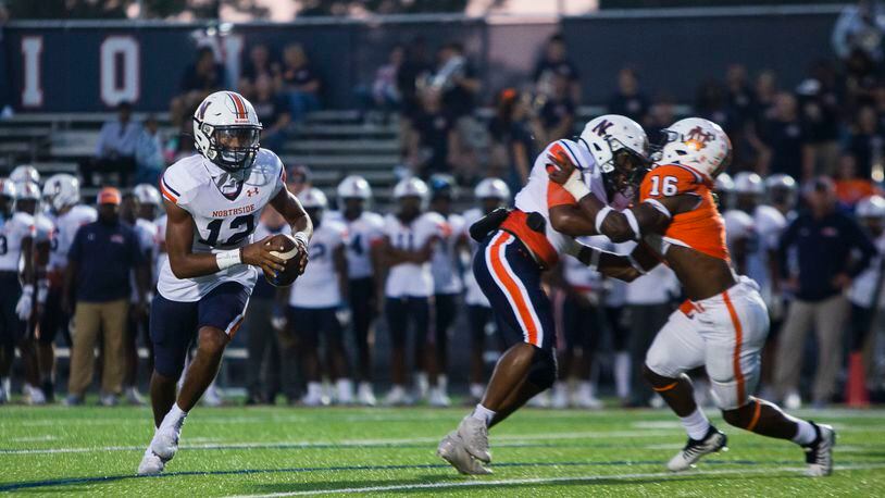 Damien Dee, quarterback for Northside, scrambles in the pocket during the North Cobb vs. Northside high school football game on Friday, September 16, 2022, in Kennesaw, Georgia. North Cobb led Northside 14-7 at the half. CHRISTINA MATACOTTA FOR THE ATLANTA JOURNAL-CONSTITUTION.