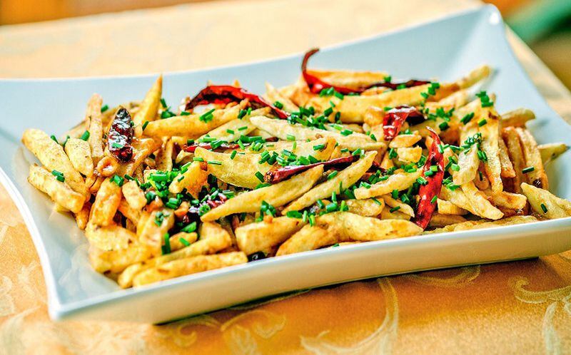Kung Pao-style russet potatoes with chives and dried red chilies. (Andrew Rush/Pittsburgh Post-Gazette/TNS)