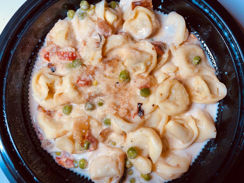 Iron Hill serves tortellini carbonara with roasted red peppers, peas, bacon, pecorino Romano and garlic cream sauce. Bob Townsend for The Atlanta Journal-Constitution 