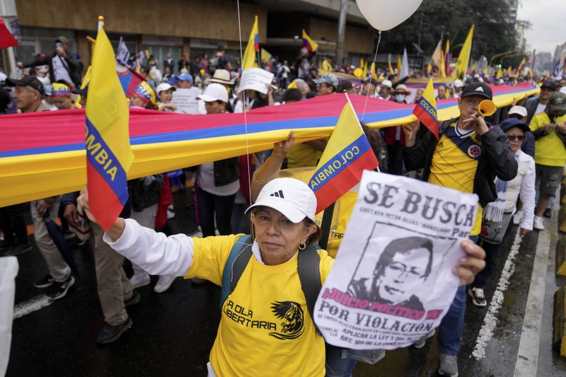 Anti-government demonstrators march to protest economic and social reforms pushed by the government of President Gustavo Petro and his proposal to convene a constituent assembly in Bogota, Colombia, Sunday, April 21, 2024. (AP Photo/Fernando Vergara)