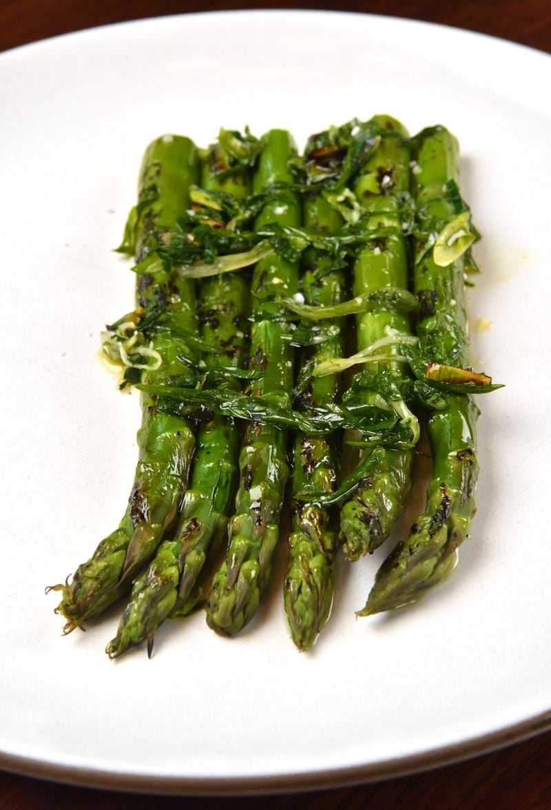 Grilled Green Asparagus with Ramps Sauce is a spring dish by Le Bon Nosh chef Forough Vakili. Ramps look like scallions, but are smaller, slightly more delicate, and often hard to find. (Styling by chef Forough Vakili / Chris Hunt for the AJC)