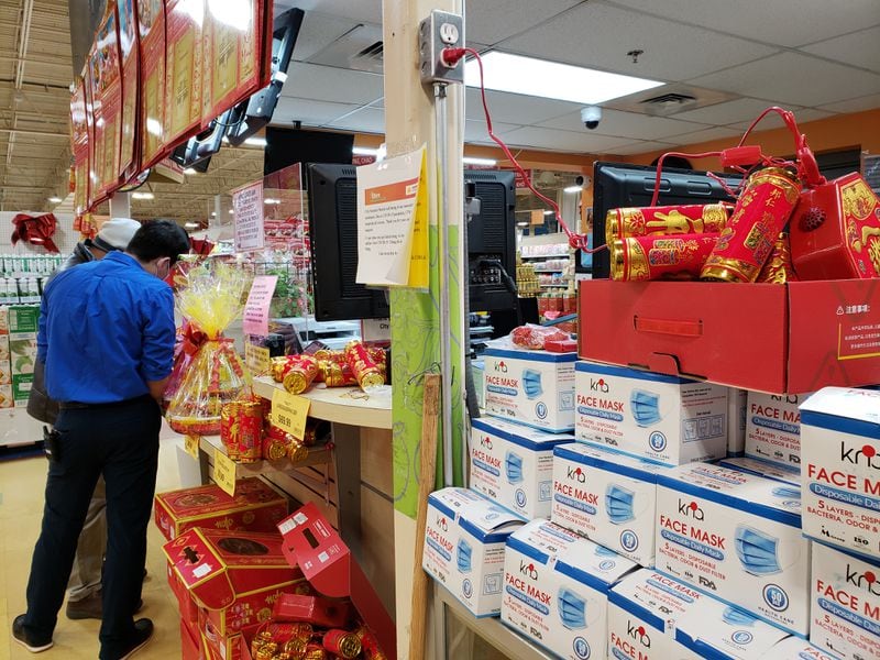 Metro Atlanta businesses and residents face the second Chinese New Year in a row impacted by the coronavirus pandemic. At City Farmers Market on Pleasant Hill Road in Duluth, displays of lunar new year decorations share space with boxes of masks that became more in demand amid COVID-19. MATT KEMPNER / AJC