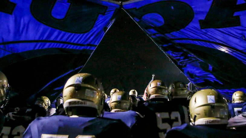 The Dacula football team breaks through their banner as they run onto the field before a game against Lanier Friday, Oct. 26, 2018, at Dacula High School in Dacula.