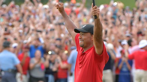 Tiger Woods celebrates as he wins the Tour Championship on the 18th green during the final round of the Tour Championship at East Lake Golf Club on Sunday, September 23, 2018.