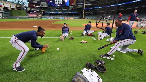 Infielders Ozzie Albies (from left), Dansby Swanson, Austin Riley and Freddie Freeman work with coach Ron Washington before playing the Astros in Game 1 of the 2021 World Series. As much as the players learn from Washington, he learns from them. (Curtis Compton / Curtis.Compton@ajc.com)
