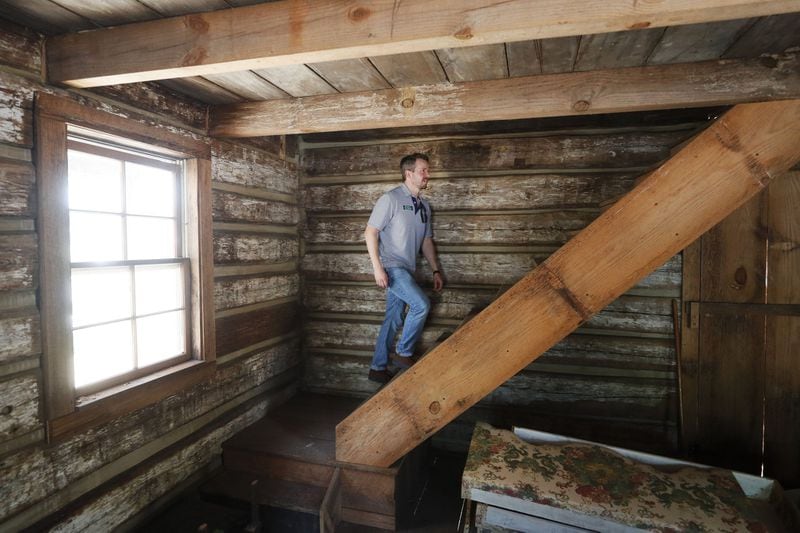 May 2, 2019 - Marietta - Trevor Beemon, executive director of the Root House, walks to the attic in the pioneer cabin that is being restored on the site. Some of the original timbers date back to the 1830s. Cobb Landmarks is renovating its William Root House Museum, an old house in downtown Marietta that showcases the lives of people in antebellum Georgia. They have began reconstructing the smokehouse and a log cabin on to the site. Bob Andres / bandres@ajc.com