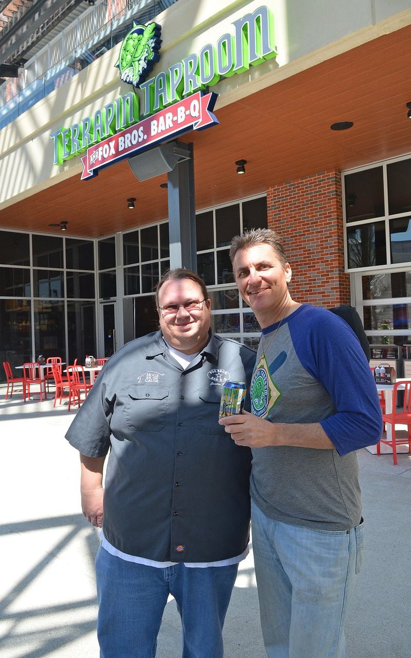 Justin Fox (of Fox Bros.) and head Terrapin brewmaster Spike Bukowski pose outside the Terrapin Taproom in The Battery Atlanta adjacent to SunTrust Park. The location, which includes the Brew Lab, has Terrapin beers and food from Fox Bros. Bar-B-Q. CONTRIBUTED BY CHRIS HUNT