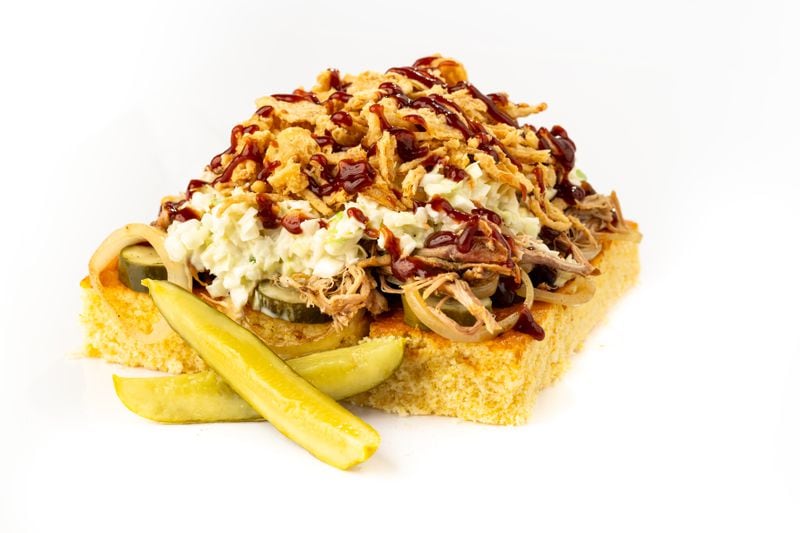 The Knuckie Sandwich, made with cornbread topped with smoked pulled pork, caramelized onions, pickles, fried onions and barbecue sauce, served at Truist Park.