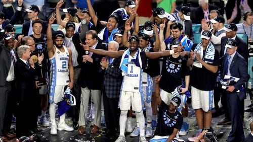 GLENDALE, AZ - APRIL 03: Joel Berry II #2 and Theo Pinson #1 of the North Carolina Tar Heels celebrate with head coach Roy Williams and their team after defeating the Gonzaga Bulldogs during the 2017 NCAA Men's Final Four National Championship game at University of Phoenix Stadium on April 3, 2017 in Glendale, Arizona. The Tar Heels defeated the Bulldogs 71-65. (Photo by Christian Petersen/Getty Images)
