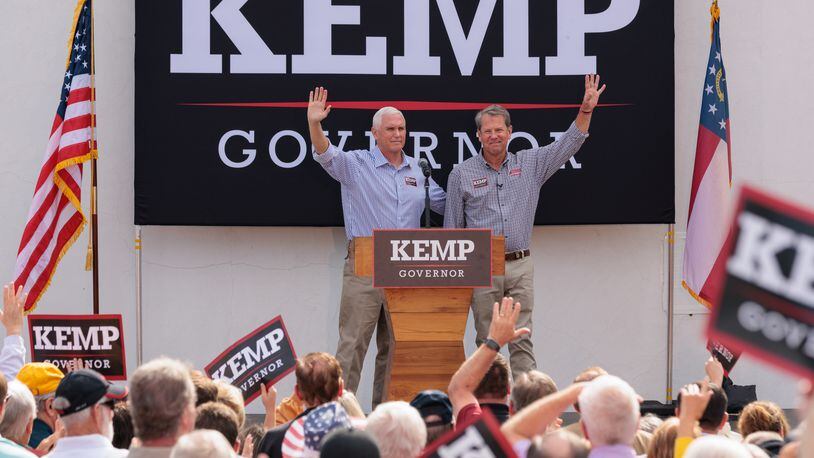 Former Vice President Mike Pence, left, campaigns Tuesday in Cumming with Gov. Brian Kemp. Pence called Kemp “singularly one of the most successful conservative governors.” (Arvin Temkar / arvin.temkar@ajc.com)