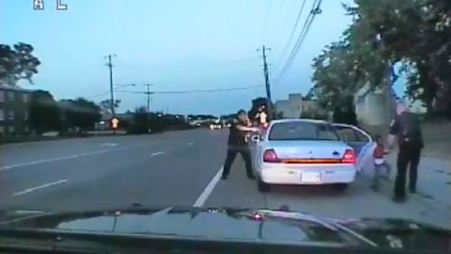 In this image made from July 6, 2016, video captured by a camera in the squad car of St. Anthony Police officer Jeronimo Yanez, the Minnesota police officer is shown after shooting into the vehicle at Philando Castile during a traffic stop in Falcon Heights, Minn., as the 4-year-old daughter of Castile's girlfriend, Diamond Reynolds, starts to get out of the car and is grabbed by an officer. The video was made public by the Minnesota Bureau of Criminal Apprehension and the Ramsey County Attorney's Office, Tuesday, June 20, 2017, just days after the officer was acquitted on all counts in the case. (St. Anthony Police Department via AP)