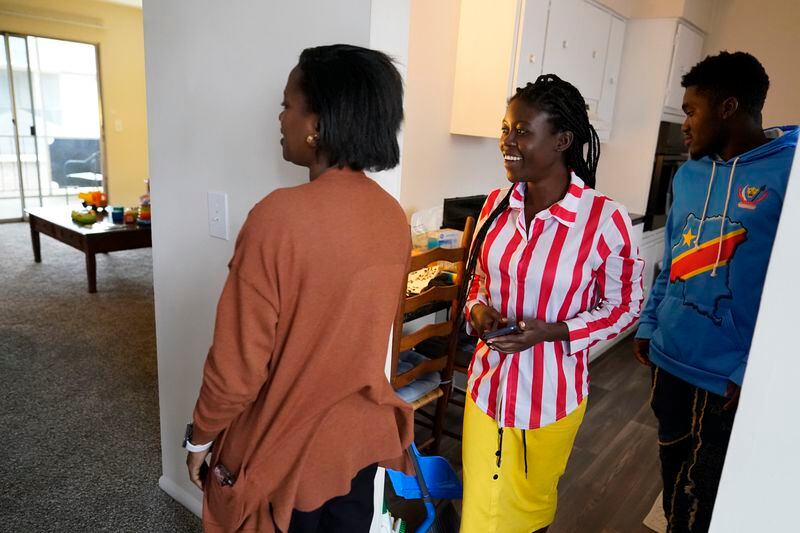 Lutheran Services Carolinas employment specialist Yvonne Songolo, from left, gives Congo refugees Riziki Kashindi and her husband Sadock Ekyochi, a tour of their new apartment, Thursday, April 11, 2024, in Columbia, S.C. The American refugee program, which long served as a haven for people fleeing violence around the world, is rebounding from years of dwindling arrivals under former President Donald Trump. The Biden administration has worked to restaff refugee resettlement agencies and streamline the process of vetting and placing people in America. (AP Photo/Erik Verduzco)