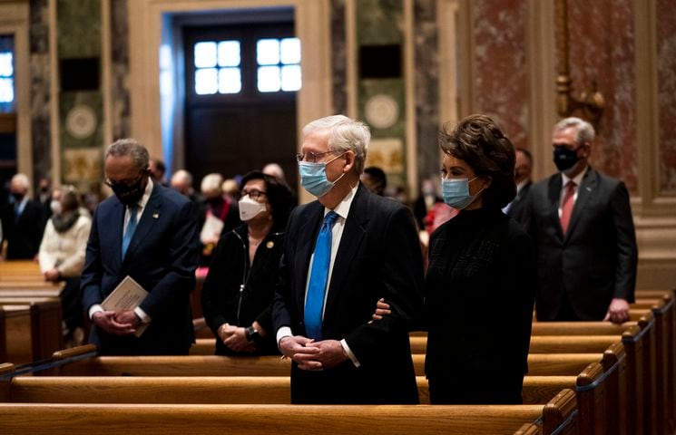 Senate Majority Leader Mitch McConnell (R-Ky.) and his wife Elaine Chao attend Mass at the Cathedral of St. Matthew the Apostle during Inauguration Day ceremonies in Washington on Wednesday, Jan. 20, 2021. (Doug Mills/The New York Times)