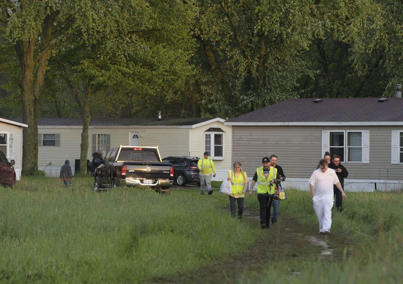 People leave after a tornado swept through the area of the Pavilion Estates mobile home park, in Kalamazoo, Mich., Tuesday, May 7, 2024. Multiple injuries were reported at the park. (J. Scott Park/Jackson Citizen Patriot via AP)