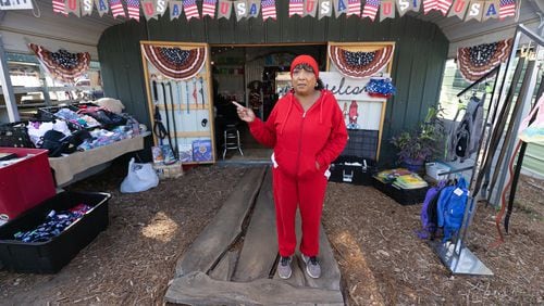 Felicia Flecha-Johnson talks about her merchandise at her booth at Sweeties Flea Market, located off U.S. 19/41, in Hampton. Steve Schaefer/steve.schaefer@ajc.com