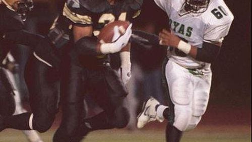Jamal Lewis (31, left) rushed for 1,947 yards and 29 touchdowns to lead Douglass to an 11-2 record and the Region 7-AAAA championship in 1995. Frank Niemeir / AJC File