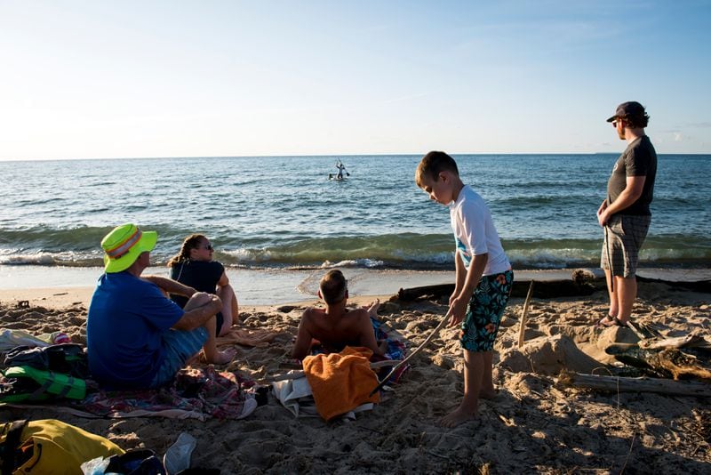 
                        FILE — Beachgoers at Sleeping Bear Dunes National Lakeshore in Michigan, Aug. 9, 2019. New beach wheelchairs will be available at Sleeping Bear Dunes National Lakeshore. (Emily Rose Bennett/The New York Times)
                      
