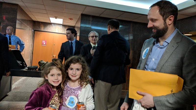Jacob Dearolph with two of his children at the state Capitol, Carter June, 7, (left) and Katy Mae, 6. They watched a Feb. 12, 2019 hearing about dyslexia during the legislative session.