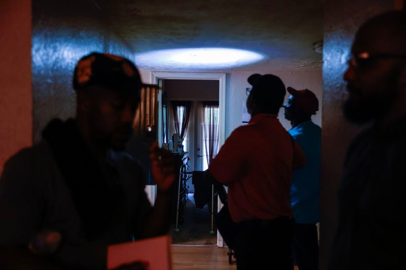 Inspectors from Atlanta’s Safe and Secure Housing program evaluate the ceiling inside an apartment at Woodland Heights in July. The detail took place after tenants made dozens of complaints about substandard living conditions. (Natrice Miller/natrice.miller@ajc.com)