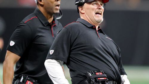 Falcons head coach Dan Quinn (right) uses body english during a field-goal attempt while playing the Washington Redskins in a NFL preseason game on Thursday, August 22, 2019, in Atlanta.  The Falcons lost 19-7. Curtis Compton/ccompton@ajc.com