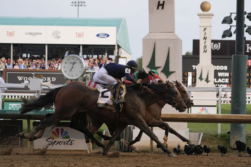 Sierra Leone, with jockey Tyler Gaffalione, (2), Forever Young, with jockey Ryusei Sakai, and Mystik, with jockey Dan Brian Hernandez Jr., cross finish line at Churchill Downs during the 150th running of the Kentucky Derby horse race Saturday, May 4, 2024, in Louisville, Ky. (AP Photo/Kiichiro Sato)