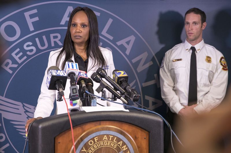 04/05/2018 -- Atlanta, GA - Fulton County Chief Medical Examiner Jan Gorniak, center, answers questions during a press conference at the Atlanta Police Department headquarters, Thursday, April 5, 2018. The medical examiner's office broke the news to the family of missing CDC researcher Timothy Cunningham, that his body was found in the Chattahoochee River. TALYSSA POINTER/ALYSSA.POINTER@AJC.COM