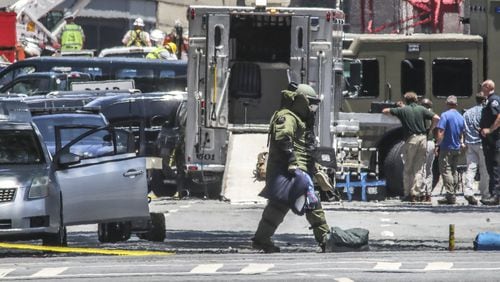 The Atlanta police bomb squad used a robot and and a bomb tech to remove contents from the suspect’s car parked on Washington Street in front of the Capitol building. JOHN SPINK/JSPINK@AJC.COM