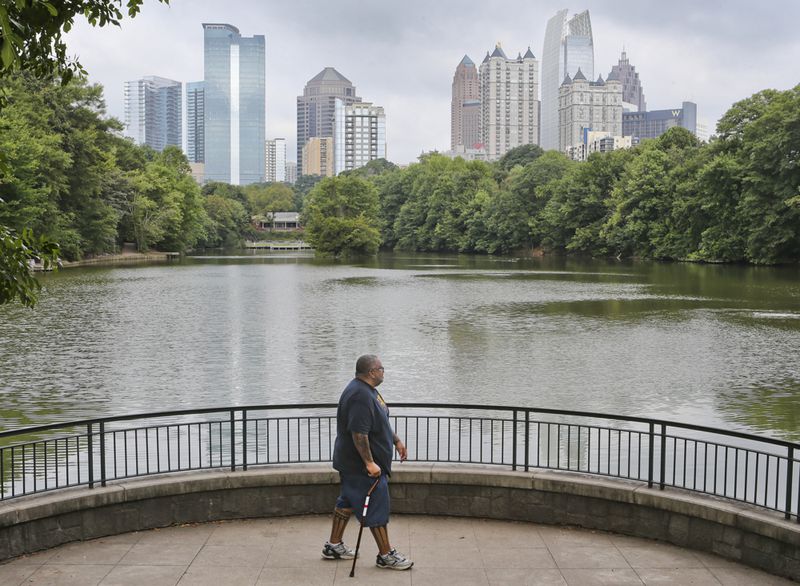 A WALK IN THE PARK-- August 18, 2014 Atlanta: Richard Hill took in the great view of the Atlanta skyline as he walked along Lake Clara Meer in Piedmont Park on Monday, Aug. 18, 2014. JOHN SPINK/JSPINK@AJC.COM