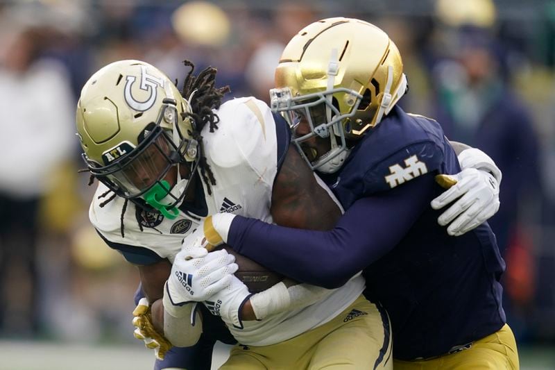 Georgia Tech's Jahmyr Gibbs (1) is tackled by Notre Dame's Clarence Lewis (6) during the first half of an NCAA college football game, Saturday, Nov. 20, 2021, in South Bend, Ind. (AP Photo/Darron Cummings)