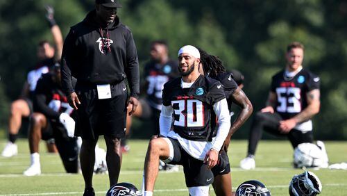 Falcons safety Jessie Bates III (30) smiles as he and teammates warm up during the first day of 2023 AT&T Atlanta Falcons Training Camp at Atlanta Falcons Corporate Headquarters and Training Facility, Wednesday, July 26, 2023, in Flowery Branch. (Hyosub Shin / Hyosub.Shin@ajc.com)