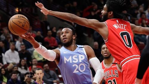 Minnesota Timberwolves guard Josh Okogie, left, shoots against Chicago Bulls guard Coby White in Chicago, Wednesday, Jan. 22, 2020. (AP Photo/Nam Y. Huh)