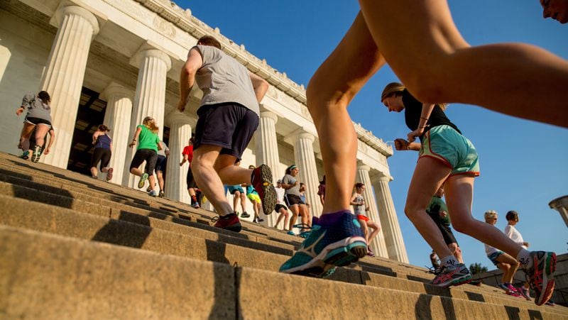 In this May 25, 2016 photo, members of the running group “November Project” run up and down the stairs of the Lincoln Memorial, in Washington. Fitness buffs around the country are bringing the ‘take the stairs’ advice to a whole new level as noteworthy landmarks have become unlikely, yet popular new workout sites. (AP Photo/Andrew Harnik)