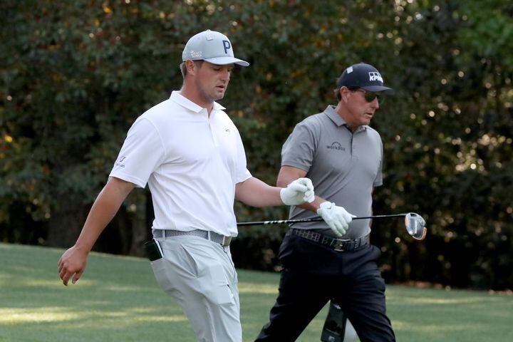 April 7, 2021, Augusta: Bryson DeChambeau, left, and Phil Mickelson walk down the eleventh fairway during their practice round for the Masters at Augusta National Golf Club on Wednesday, April 7, 2021, in Augusta. Curtis Compton/ccompton@ajc.com