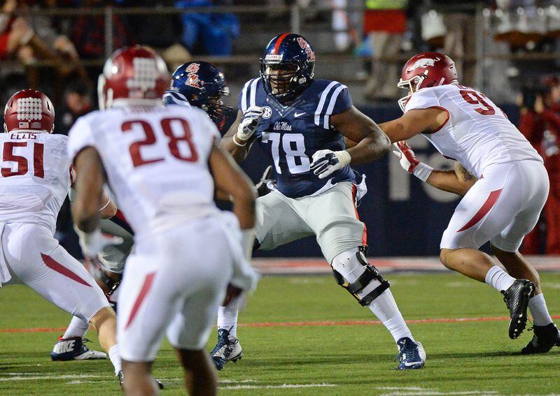 Mississippi offensive lineman Laremy Tunsil (78) blocks Arkansas players during the second half of an NCAA college football game in Oxford, Miss., Saturday, Nov. 7, 2015. Arkansas beat No. 19 Mississippi 53-52 in overtime. (AP Photo/Thomas Graning)