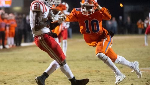 Archer wide receiver Andrew Booth makes a catch as Parkview corner back Matt Chavers (10) defends during a high school football game Fri., Nov. 16, 2018, in Lilburn.