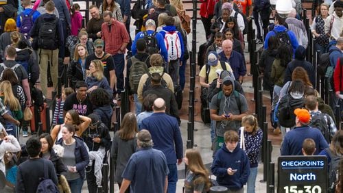 Travelers weave through a long line to get to the security checkpoint at Hartsfield-Jackson International Airport Sunday on what is expected to set a record travel day for the U.S. airline industry on December 1, 2019.  (Photo: STEVE SCHAEFER / SPECIAL TO THE AJC)
