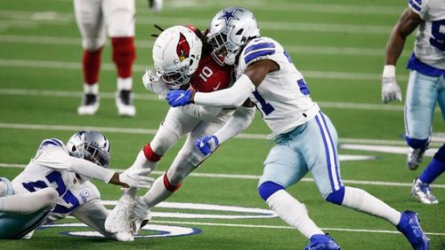 Arizona Cardinals wide receiver DeAndre Hopkins (10) is brought down by Dallas Cowboys cornerback Trevon Diggs (27) and Dallas Cowboys safety Donovan Wilson (37) during the first quarter of play at AT&T Stadium on Monday, Oct. 19, 2020 in Arlington, Texas. (Vernon Bryant/The Dallas Morning News/TNS) 