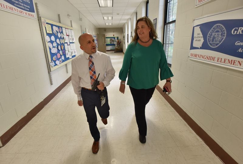 School Business Manager Brian Baron and Principal Audrey Sofianos talk as they walk down the hall at Morningside Elementary School on Friday, September 28, 2018. HYOSUB SHIN / HSHIN@AJC.COM