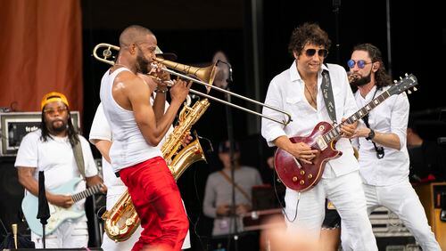 Trombone Shorty, left, and Pete Murano of Trombone Shorty & Orleans Avenue perform at the 2023 New Orleans Jazz & Heritage Festival on Sunday, May 7, 2023, at the Fair Grounds Race Course in New Orleans. (Photo by Amy Harris/Invision/AP)