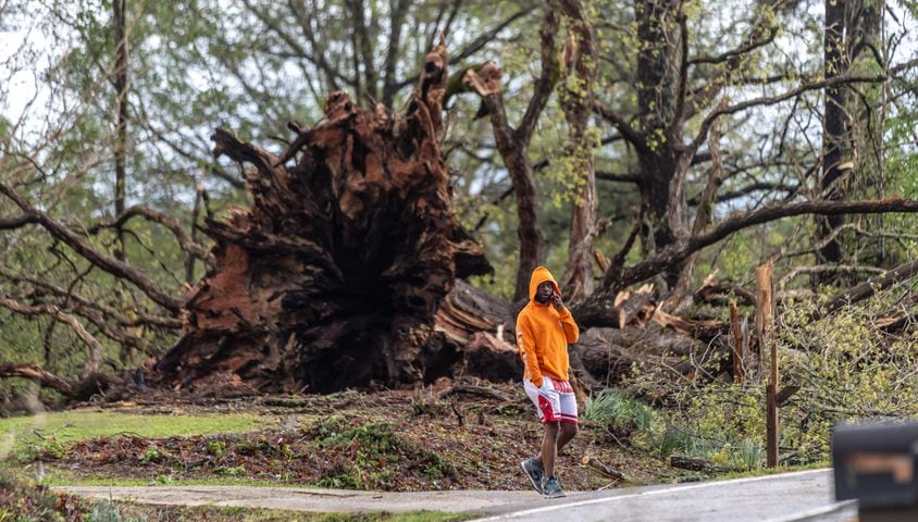 Charlie Brooks surveys storm damage at on McDaniel Mill Road on Wednesday, April 3, 2024, after a night of turbulent storms in Rockdale County, where at least one tornado was reported to have touched down. (John Spink / John.Spink@ajc.com)