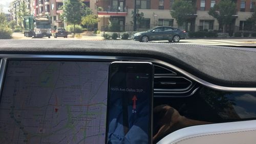 The Travel Safely application is demonstrated by A.I. President Bryan Mulligan while driving his autonomous Tesla Model S on North Avenue. Doug Turnbull for the AJC