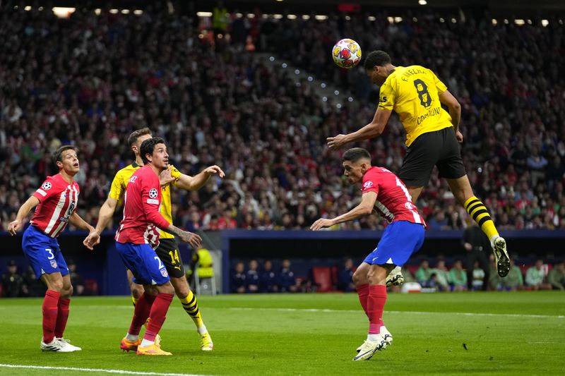 Dortmund's Felix Nmecha, right, makes an attempt to score during the Champions League quarterfinal soccer match between Atletico Madrid and Borussia Dortmund at the Metropolitano stadium in Madrid, Spain, Wednesday, April 10, 2024. (AP Photo/Manu Fernandez)
