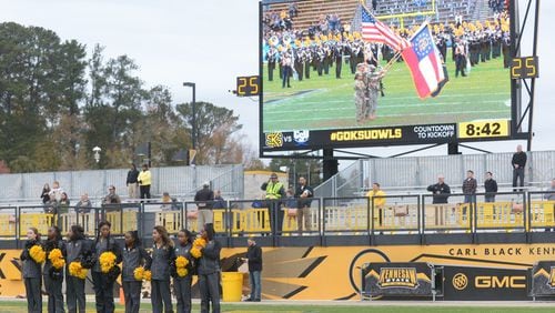 Some of the Kennesaw State University cheerleaders link arms in the north end zone of KSU’s Fifth Third Bank Stadium during the national anthem prior to the start of the football game Saturday, Nov. 11, 2017. This marked the cheerleaders’ return to the field in the wake of some taking a knee during the national anthem in previous games. Photo: Daniel Varnado / Special to the AJC
