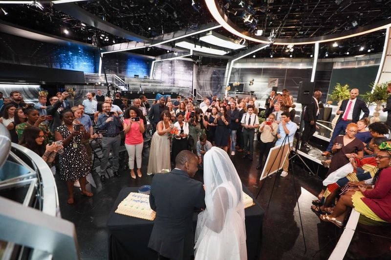 Destinee and Anthony Baker still got to cut their wedding cake after Hurricane Dorian forced them to cancel their wedding plans in Charleston. They got married at work, Turner Studios in Atlanta, instead on Friday, September 6, 2019. (D'Marcus Pulse/Turner Studios/contributed photo to AJC)