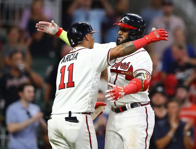 Braves designated hitter Marcell Ozuna gets a hug from Orlando Arcia after hitting a solo homer to take a 10-1 lead over the Philadelphia Phillies during the seventh inning of a MLB baseball game on Tuesday, August 2, 2022, in Atlanta.   “Curtis Compton / Curtis Compton@ajc.com