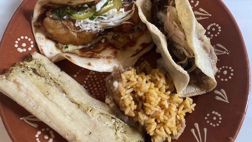 This takeout order from Good Word, plated at home, includes a carne asada taco, pollo verde tamale, Mexican rice and beans. CONTRIBUTED BY BOB TOWNSEND