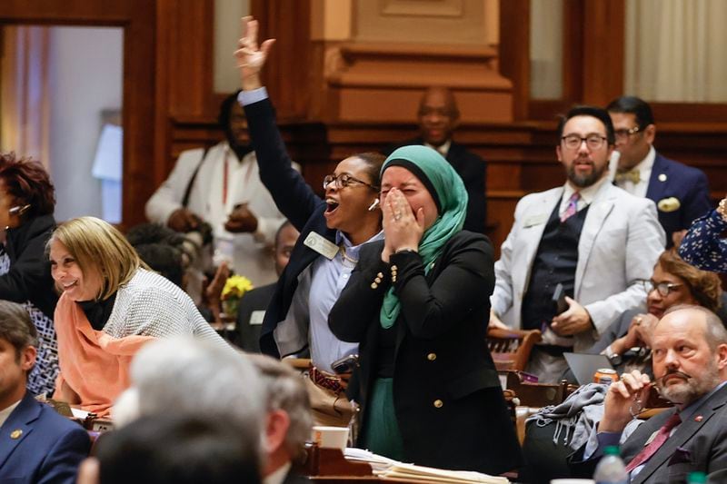 Rep. Imani Barnes (D-Tucker) and Rep. Ruwa Romman (D-Duluth) cheer after Senate Bill 233 fails to pass in the Georgia House on Wednesday, March 29, 2023. The bill would send $6,500 a year to parents to help cover education-related costs, including private school tuition. (Natrice Miller/ natrice.miller@ajc.com) 